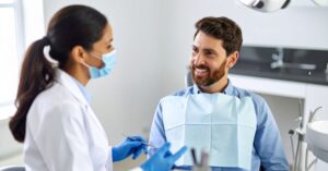 How Much Does a Tooth Implant Cost in Crystal Lake? 1 “patient discussing tooth implant options with dentist”