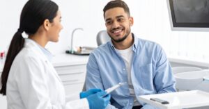 Affordable Dentures: Restoring Your Smile Without Breaking the Bank 3 patient discussing denture financing options with dentist