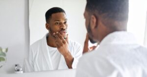 Metallic Taste in Your Mouth? Causes and When to See a Dentist 1 patient noticing metallic taste in mouth and checking oral health”)