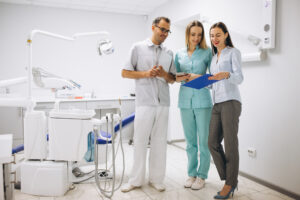 Full Mouth Dental Implants After Years of Dentures: What Are Your Options? 4 Dentistry team in office