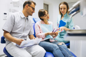 Looking for a Dentist Near Algonquin, IL? Here’s What Families Should Know 1 Family discussing dental treatment options with dentist in consultation room