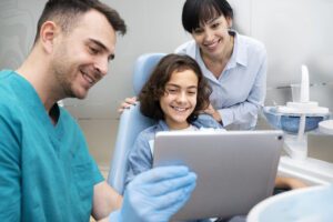 Dentist Near Me Accepting New Patients in Crystal Lake: What to Look For Before Booking 2 Parents and child visiting a family dentist for a routine dental appointment.