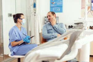 Emergency Dentist in Crystal Lake: What to Do in a Dental Emergency 2 Dental professional discussing treatment options and insurance benefits with a patient during a consultation