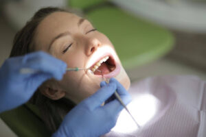 How Long After a Dental Cleaning Can I Eat? 1 Patient receiving a professional dental cleaning and fluoride treatment during a routine preventive dental visit.
