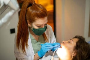 Dentist Near Woodstock, IL: What to Look for When Choosing the Right Dental Provider 2 Dentist performing a routine dental exam and treatment for a patient at a family dental office in Crystal Lake.