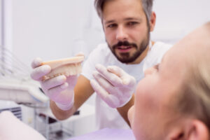 How Long Does a Dental Bridge Last? Tips to Extend Its Lifespan 1 Dental bridge anchored between two supporting teeth.