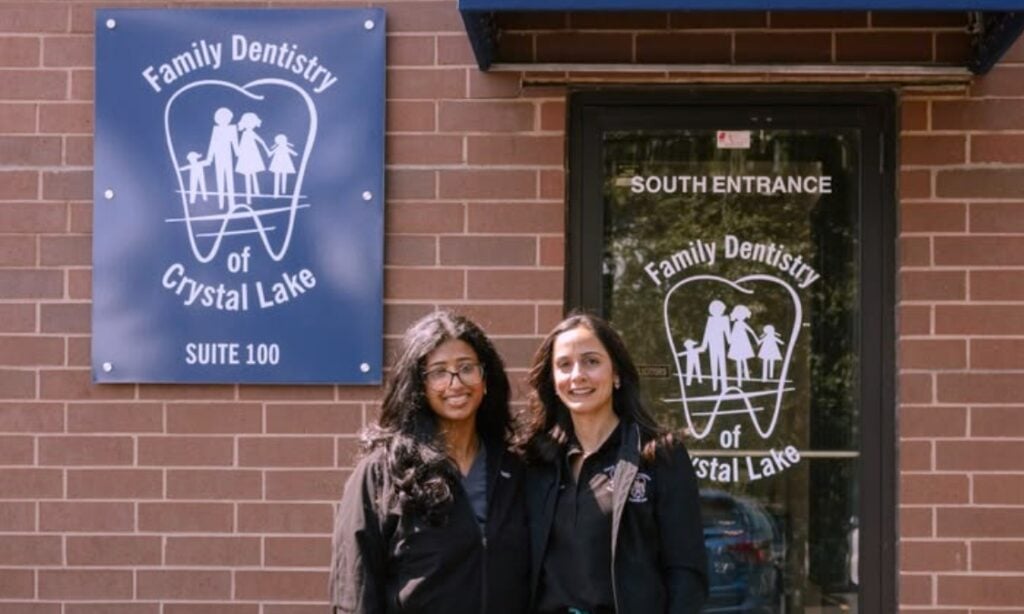 Two dental team members standing outside the south entrance of Family Dentistry of Crystal Lake, Suite 100
