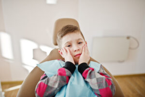 Cavities in Kids: Treatment, Prevention & Cost in Crystal Lake, IL (2026) 1 Child experiencing tooth pain from a cavity.
