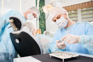 Dental Crowns in Crystal Lake: Types, Cost & What to Expect in 2026 1 Dentist and assistant performing a dental procedure on a patient in a treatment room.